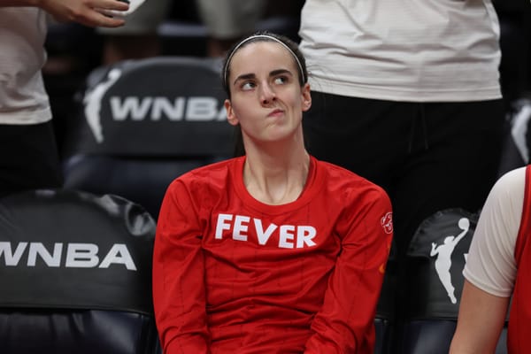 Caitlin Clark on the Indiana Fever sideline during a WNBA game