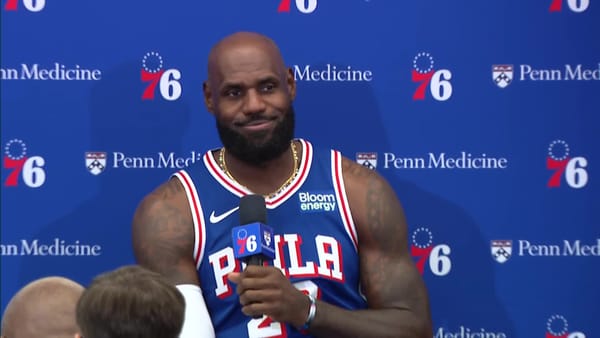 LeBron James speaks to reporters in a Philadelphia 76ers uniform at 76ers Media Day