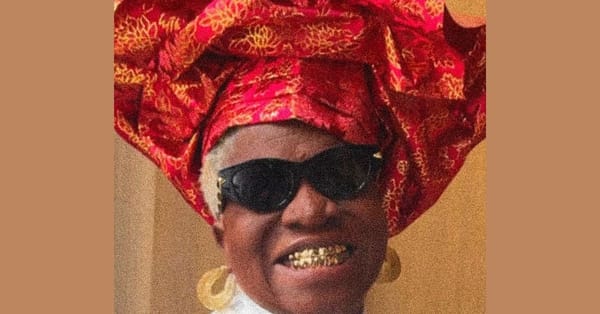 Tobe Nwigwe's mother wears a gold grill and a red Ankara headwrap on the cover of THE BRIDGE